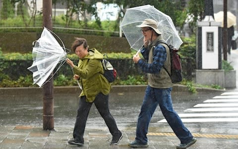 A powerful typhoon barrelled toward Japan on Sunday, with heavy rain triggering landslides - Credit: KAZUHIRO NOGI/AFP/Getty Images