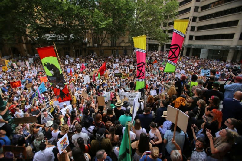 Protesters hold placards during a climate change rally in Sydney