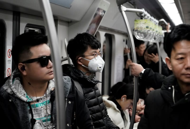 Man wearing a mask is pictured on the subway in Beijing