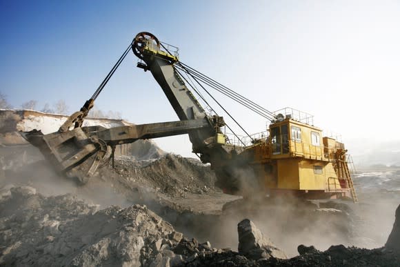 An industrial machine digging at a surface mine.