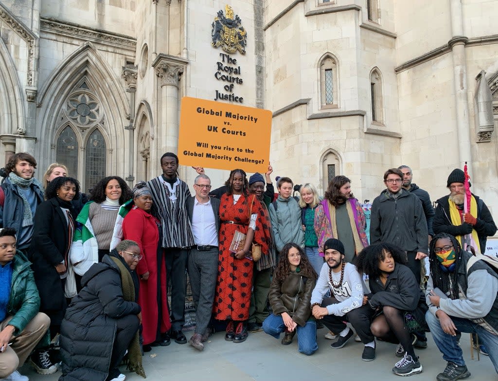 Climate activists outside the Royal Courts of Justice in London (PA)