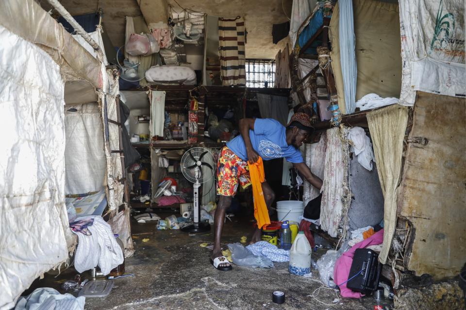 An inmate stands at the National Penitentiary in downtown Port-au-Prince, Haiti, Sunday, March 3, 2024. Hundreds of inmates have fled Haiti's main prison after armed gangs stormed the facility overnight. (AP Photo/Odelyn Joseph)