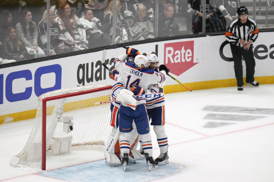 Edmonton Oilers goaltender Stuart Skinner (74), defenseman Mattias Ekholm (14) and defenseman Darnell Nurse (25) celebrate the team's 5-4 win against the Los Angeles Kings in Game 6 of an NHL hockey Stanley Cup first-round playoff series in Los Angeles on Saturday, April 29, 2023.(AP Photo/Jae C. Hong)