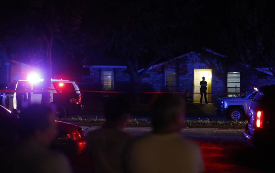 nlookers watch police work the scene of a shooting at a home in Plano, north of Dallas: AP