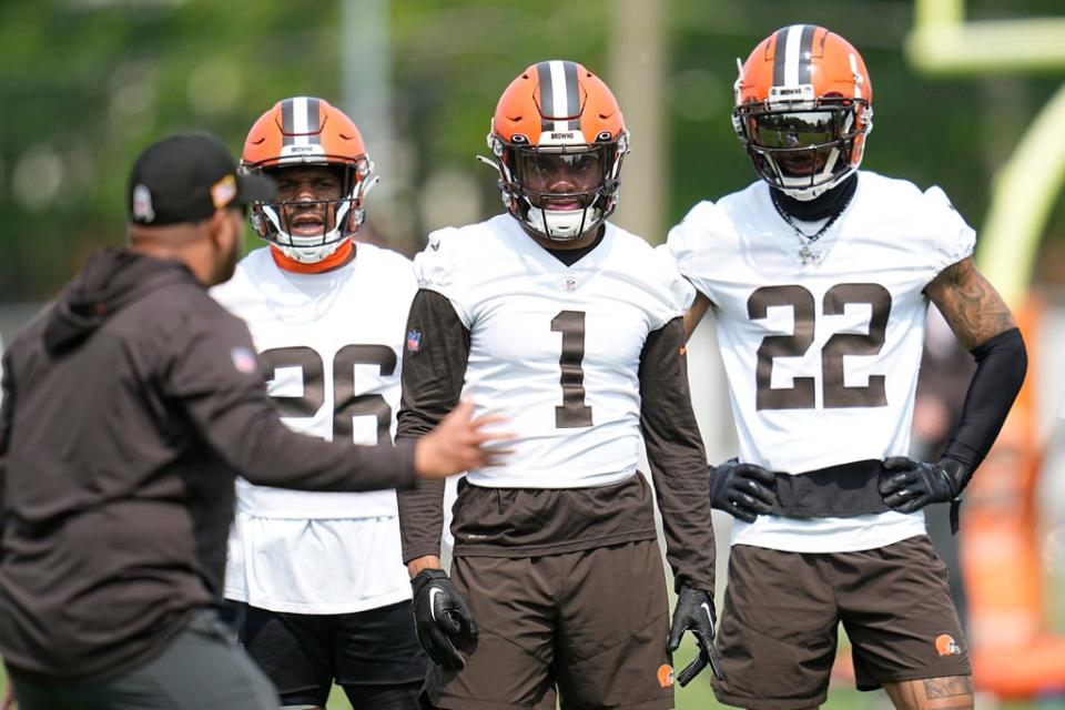Cleveland Browns safeties Rodney McLeod (26), Juan Thornhill (1) and Grant Delpit (22) listen to instruction during practice Wednesday, May 24, in Berea.