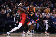 New York Knicks forward Julius Randle (30) drives to the basket against Portland Trail Blazers forward Jerami Grant during the first half of an NBA basketball game Friday, Nov. 25, 2022, in New York. (AP Photo/Adam Hunger)