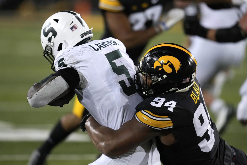 Michigan State running back Nathan Carter (5) is tackled by Iowa defensive lineman Yahya Black (94) after catching a pass during the first half of an NCAA college football game, Saturday, Sept. 30, 2023, in Iowa City, Iowa. (AP Photo/Charlie Neibergall)