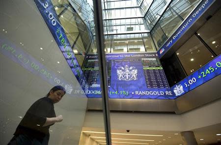 Electronic information boards display market information at the London Stock Exchange in the City of London January 2, 2013. REUTERS/Paul Hackett