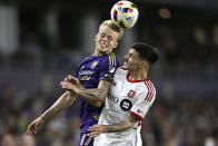 Orlando City midfielder Dagur Dan Thorhallsson (17) and Toronto FC defender Raoul Petretta, right, compete for a head ball during the second half of an MLS soccer match Saturday, April 27, 2024, in Orlando, Fla. (AP Photo/Phelan M. Ebenhack)