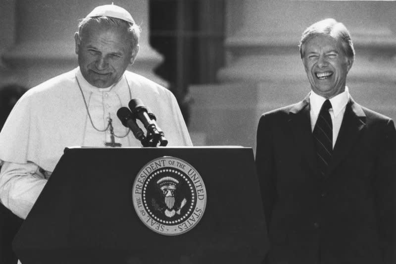 President Jimmy Carter breaks into laughter at a remark by Pope John Paul II at a reception on the South Lawn of the White House. UPI Photo/File