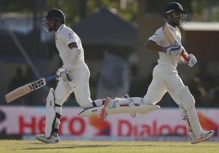 India's Ajinkya Rahane (R) and Murali Vijay run between wickets during the third day of their second test cricket match against Sri Lanka in Colombo August 22, 2015. REUTERS/Dinuka Liyanawatte