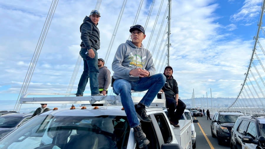 Ruben Pineda and his roofing crew wait for police to clear protesters blocking the San Francisco-Oakland Bay Bridge while demonstrating against the APEC (Asia-Pacific Economic Cooperation) summit and for Palestinians on Thursday, Nov. 16, 2023, in San Francisco. Pineda, who was stuck for several hours, said the crew would most likely lose a day of pay. (AP Photo/Noah Berger)