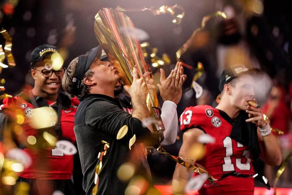 Georgia head coach Kirby Smart kisses the trophy after the Bulldogs won their second consecutive college football national championship last season. The title was the SEC’s 15th in the last 20 years.