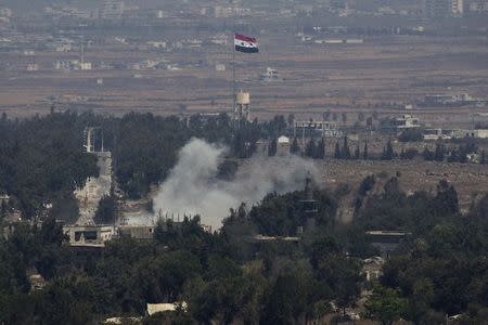 Smoke rises following an explosion on the Syrian side near the Quneitra border crossing between the Israeli-controlled Golan Heights and Syria August 29, 2014. REUTERS/Ronen Zvulun