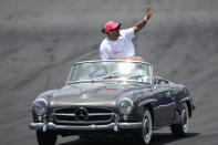 Mercedes driver Lewis Hamilton (44) of Team Great Britain waves to the crowd during the drivers' parade before the Formula One Miami Grand Prix auto race at the Miami International Autodrome, Sunday, May 7, 2023, in Miami Gardens, Fla. (AP Photo/Wilfredo Lee)