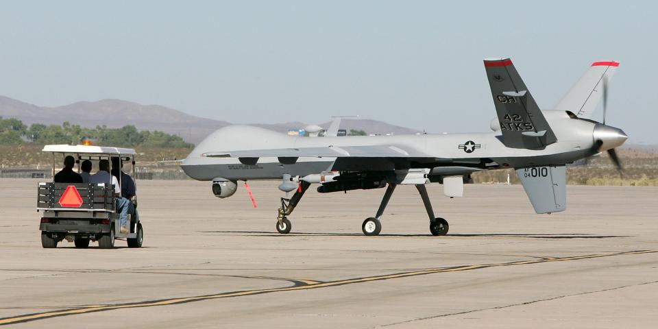 Mechanics trail an MQ-9 Reaper as it taxis for takeoff August 8, 2007 at Creech Air Force Base in Indian Springs, Nevada.