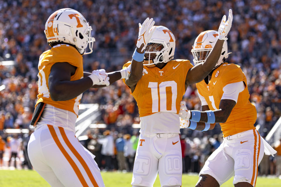 Tennessee wide receiver Squirrel White (10) celebrates a touchdown with teammates Kaleb Webb (84) and Dont'e Thornton Jr. (1) during the first half of an NCAA college football game against UConn, Saturday, Nov. 4, 2023, in Knoxville, Tenn. (AP Photo/Wade Payne)