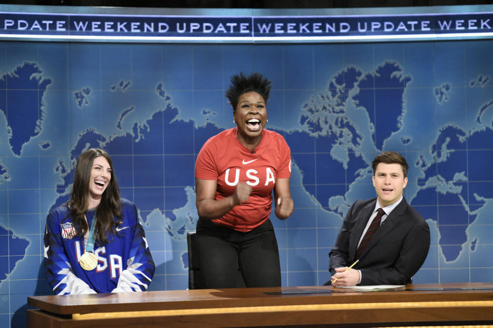 This March 3, 2018 photo released by NBC shows Leslie Jones, center, flanked by Ice Hockey Olympian Hilary Knight, left, and Colin Jost during the "Weekend Update" segment on "Saturday Night Live," in New York. Jones is leaving the NBC show after five seasons. Earlier this month, Jones announced she's doing a Netflix stand-up special. In an appearance on Jimmy Kimmel's show, Jones said it's great to be an actress but that she's really a "hardcore" stand-up comedian. (Will Heath/NBC via AP)