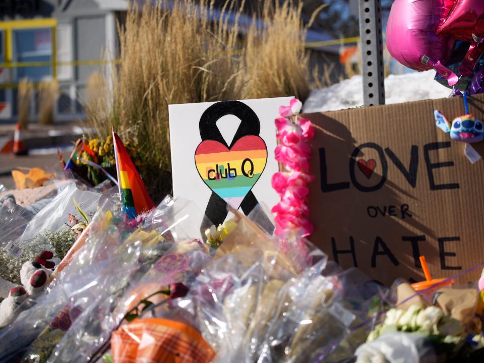 Flowers and signs for a memorial for Club Q victims.