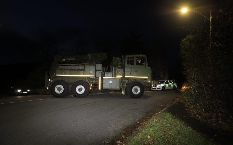 A vehicle carrying heavy lifting gear arrives at Garreg Ilanfrothen on the A4085