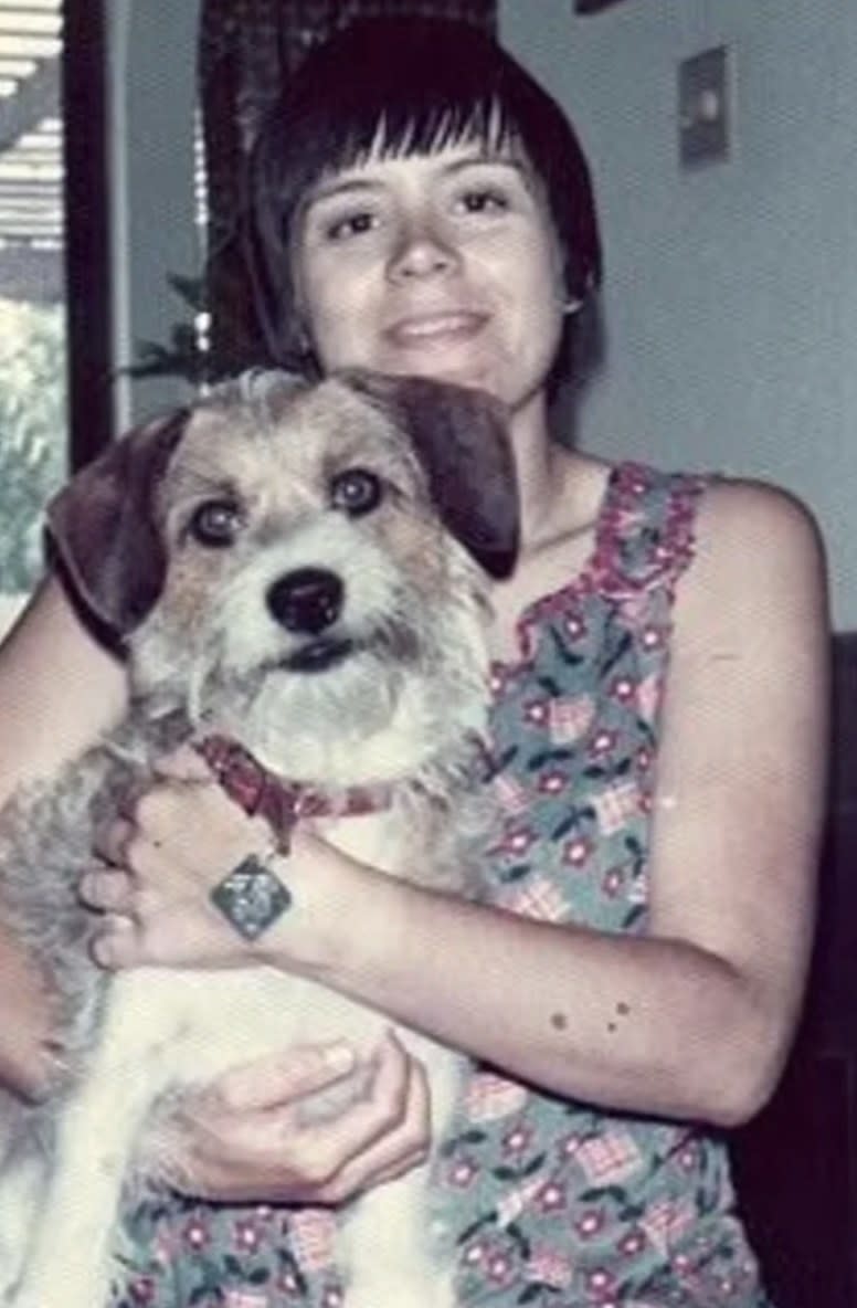 betty gore holding a dog and smiling