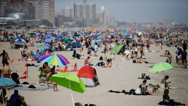 People enjoy the beach at Coney Island Friday, July 19, 2019, in the Brooklyn borough of New York.