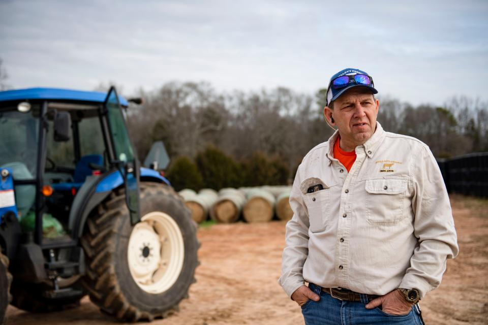 Allen Kellett, third-generation farmer and owner of Kellett Farms, talks to a client after loading bales of hay onto a truck on his farm on Saturday, Feb. 10, 2024.