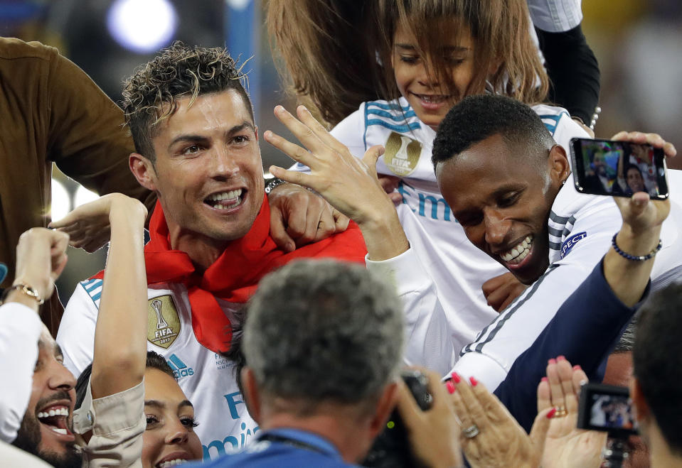 FILE - In this Saturday, May 26, 2018 file photo Real Madrid's Cristiano Ronaldo celebrates with fans after winning the Champions League Final soccer match between Real Madrid and Liverpool at the Olimpiyskiy Stadium in Kiev, Ukraine. R is for Ronaldo. With his 128 goals and 5 titles Cristiano Ronaldo is arguably the greatest Champions League player of all time. (AP Photo/Sergei Grits, File)