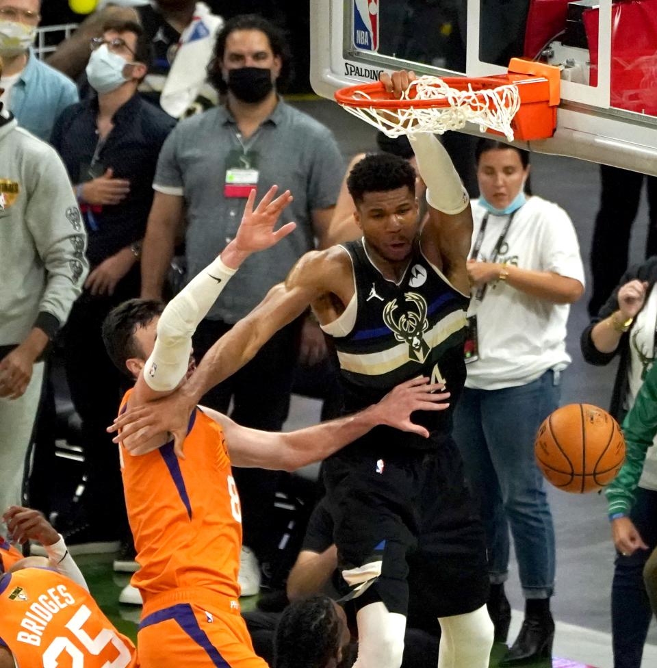 Milwaukee Bucks forward Giannis Antetokounmpo (34) dunks it as Phoenix Suns forward Frank Kaminsky (8) tries to block it during the fourth quarter of Game 6 of the NBA Finals at Fiserv Forum in Milwaukee on Tuesday, July 20, 2021.