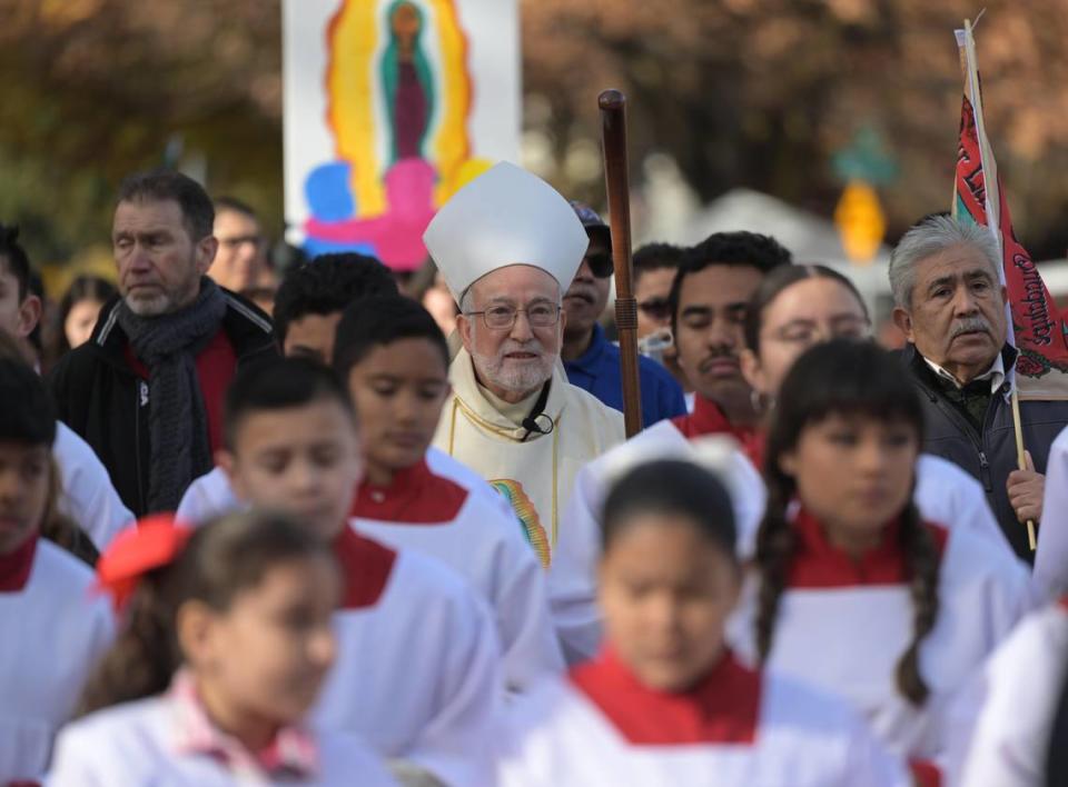 Bishop Jaime Soto, center, marches in a procession to honor Our Lady of Guadalupe, one of the patron saints of the Sacramento diocese, toward the T Street church that bears her name on Sunday, the day after the diocese announced that it would file for bankruptcy protection in the wake of hundreds of sexual abuse lawsuits.