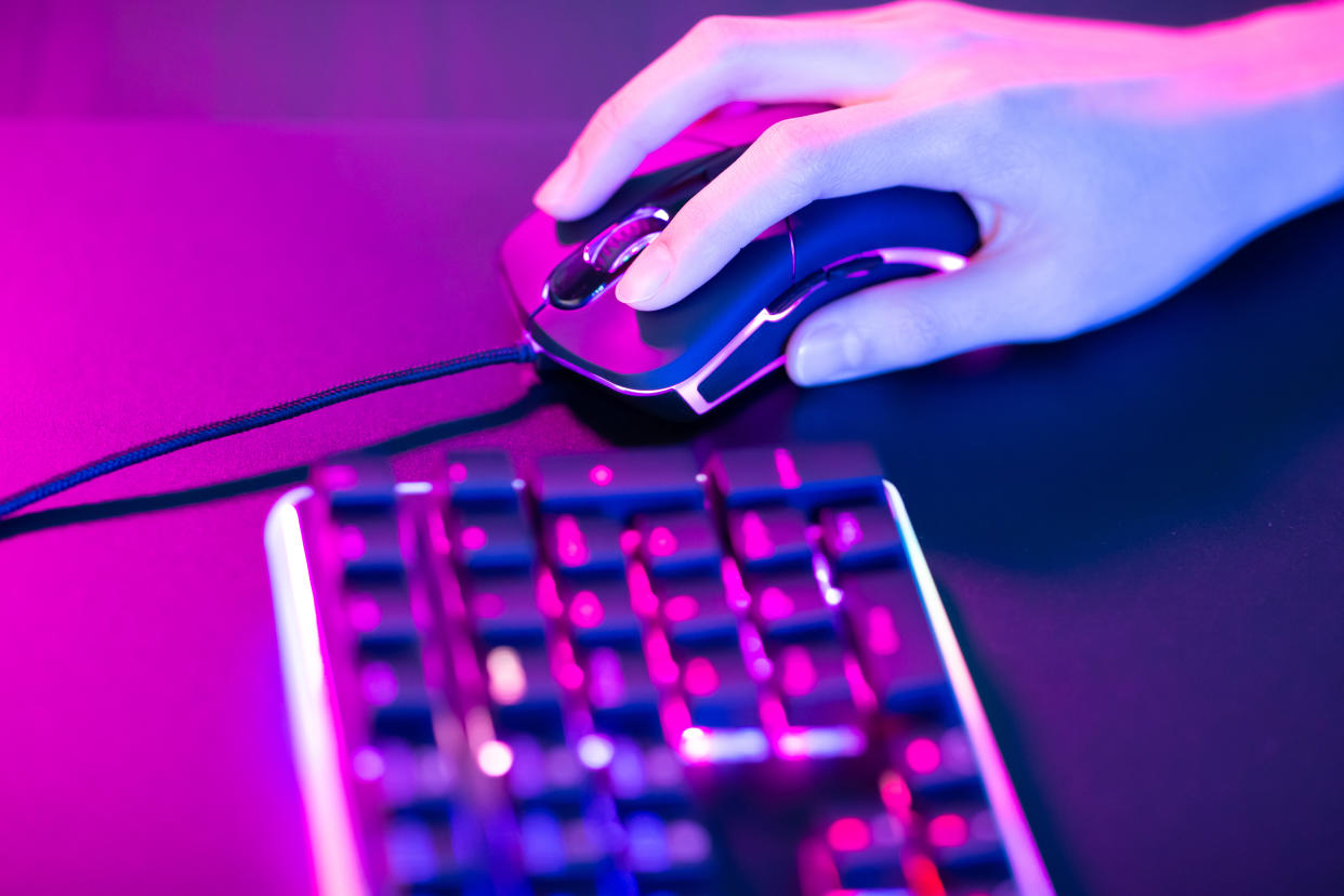 close up of pro cyber sport gamer play game with RGB keyboard and mouse