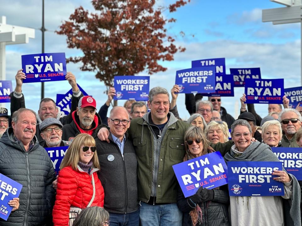 Jim Obergefell and Democratic US Senate candidate Tim Ryan pose for a photo with supporters in Sandusky, OH on October 27, 2022.