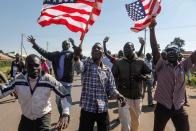 <p>Supporters of former US president Barack Obama wave US flags as they cheer to welcome Obama during an opening ceremony of the Sauti Kuu Sports, Vocational and Training Centre in his ancestral home Kogelo, some 400km west of the capital Nairobi, Kenya on July 16, 2018. (Photo: Dai Kurokawa/EPA-EFE/REX/Shutterstock) </p>