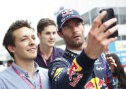 Red Bull Formula One driver Mark Webber of Australia takes a photo of himself with a fan during the Indian F1 Grand Prix at the Buddh International Circuit in Greater Noida, on the outskirts of New Delhi, October 25, 2013. REUTERS/Anindito Mukherjee (INDIA - Tags: SPORT MOTORSPORT F1)