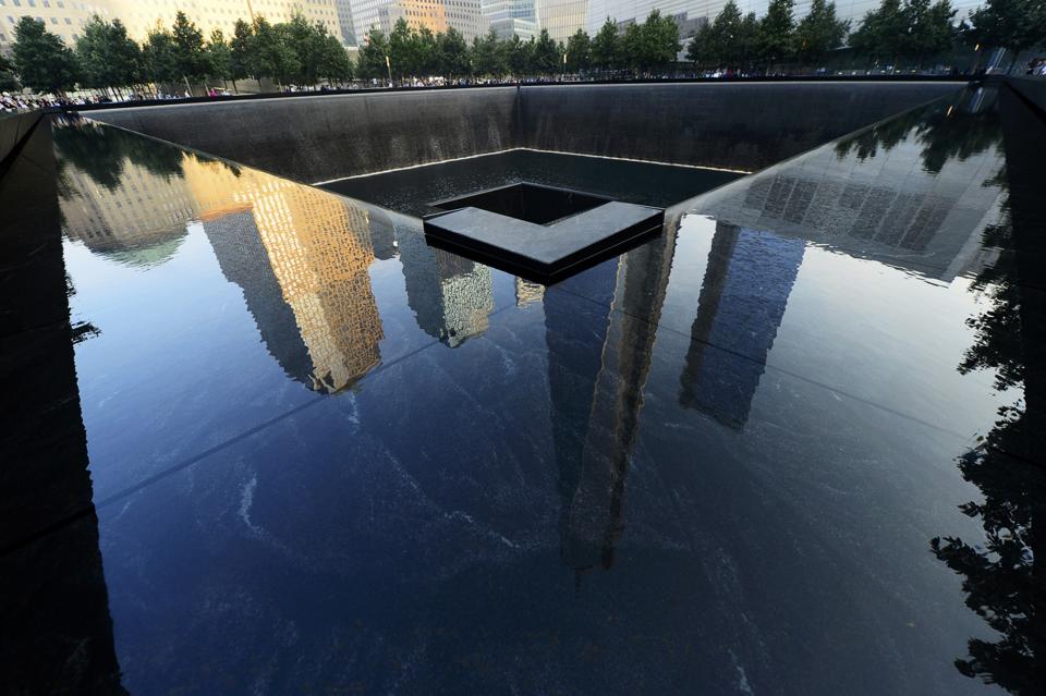 Friends and family members gather at the 9/11 Memorial during ceremonies marking the 12th anniversary of the 9/11 attacks on the World Trade Center in New York September 11, 2013. (REUTERS/Alejandra Villa)