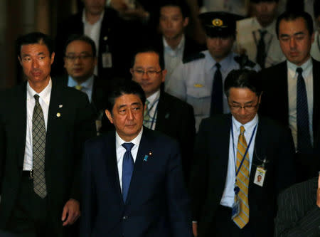 Japan's Prime Minister Shinzo Abe (front) walks after attending a lower house budget committee session at the parliament in Tokyo, Japan July 24, 2017. REUTERS/Toru Hanai