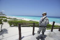 A Mexican soldier stands guard on a beach ahead of Hurricane Beryl's expected arrival, in Cancun, Mexico, Wednesday, July 3, 2024. (AP Photo/Fernando Llano)