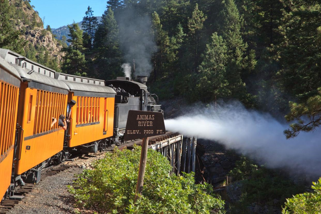 colorado: durango & silverton narrow gauge railroad passing over animas river
