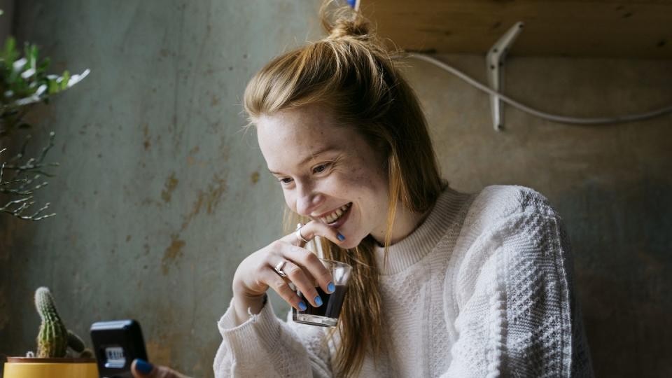 girl relaxing with coffee and video calling partner