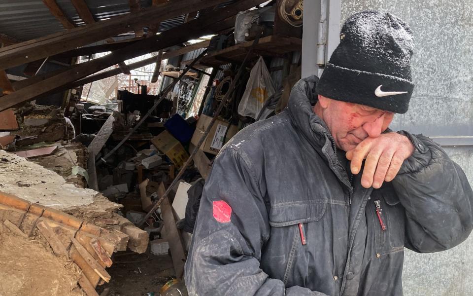 Ivan Smacheliuk, 63, stands wounded in front of his destroyed garage in Zmiiv, Ukraine after a Russian missile which left his sister, 63, dead