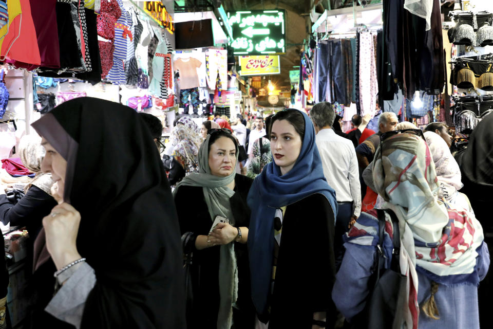 People shop at the old main bazaar in Tehran, Iran, Tuesday, July 2, 2019. From an English-language teacher hoping for peace to an appliance salesman who applauded Donald Trump as a “successful businessman,” all said they suffered from the economic hardships sparked by re-imposed and newly created American sanctions. (AP Photo/Ebrahim Noroozi)