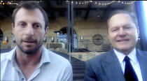 This still image from video shows New York Mets pitcher Max Scherzer, left, and agent Scott Boras as they participate in a news conference, Wednesday, Dec. 1, 2021. The Mets and three-time Cy Young Award winner Scherzer finalized a $130 million, three-year deal Wednesday, a contract that shattered baseball's record for highest average salary and forms a historically impressive 1-2 atop New York's rotation with Jacob deGrom. (New York Mets via AP)