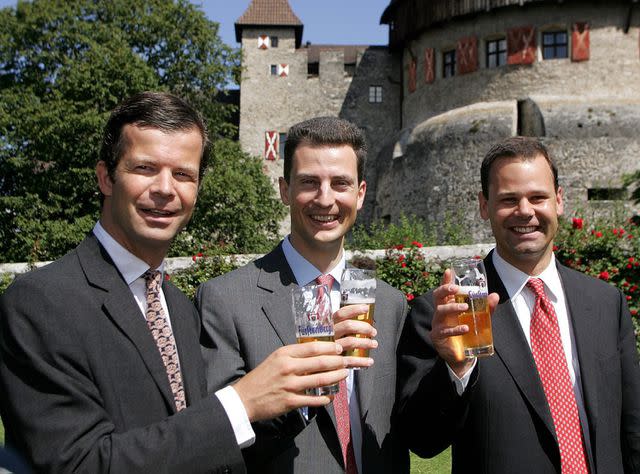 <p>Arno Balzarini/EPA/Shutterstock</p> Brothers Prince Maximilian (l) and Constantin (r) Toast with Crown Prince Alois of Liechtenstein at an event in 2004.