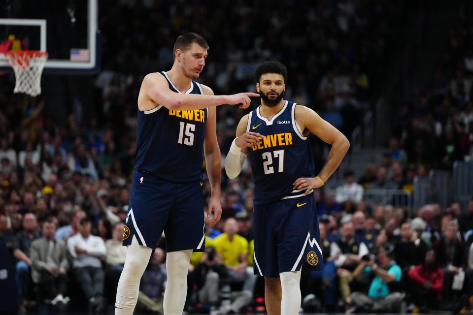 Apr 10, 2024; Denver, Colorado, USA; Denver Nuggets center Nikola Jokic (15) and guard Jamal Murray (27) talk in the fourth quarter against the Minnesota Timberwolves at Ball Arena. Mandatory Credit: Ron Chenoy-USA TODAY Sports