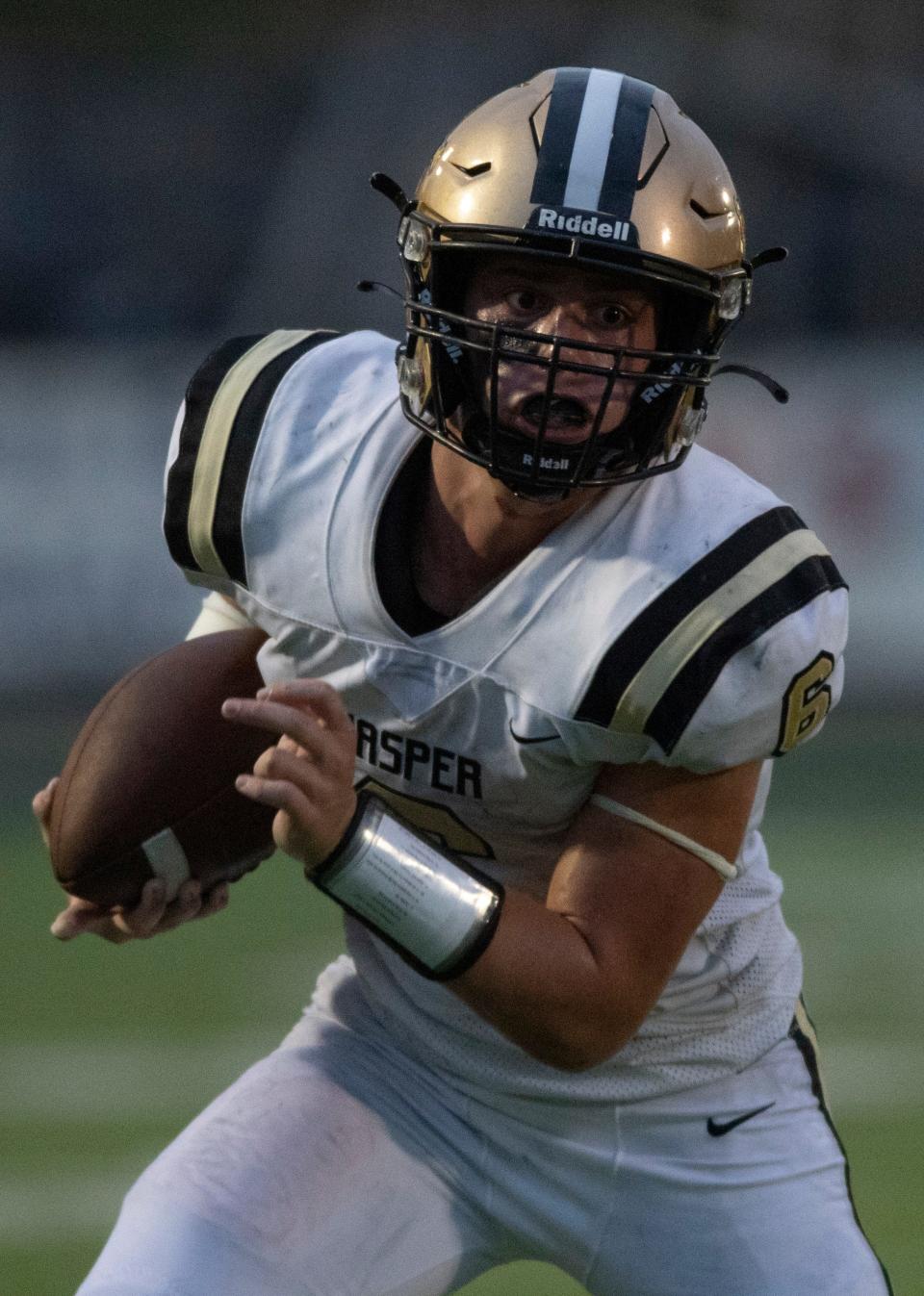 Jasper’s Carter Holsworth (6) carries the ball as the Jasper Wildcats play the Reitz Panthers at the Reitz Bowl in Evansville, Ind., Friday evening, Sept. 2, 2022. 