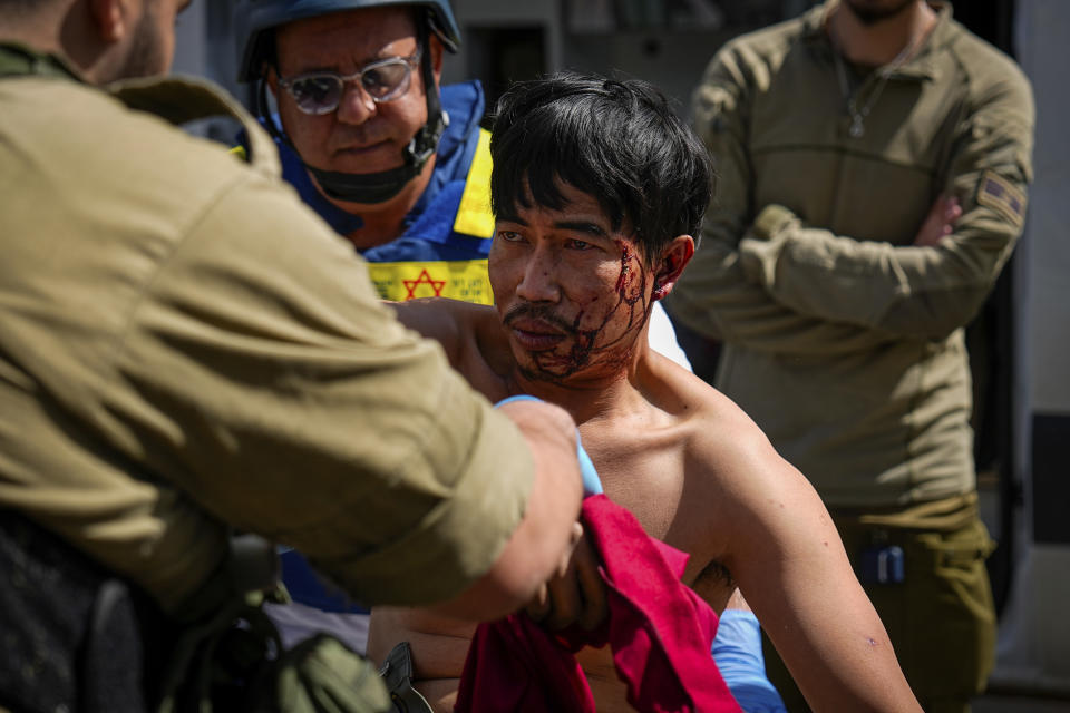 Israeli security forces in Kiryat Shoma, northern Israel, evacuate a wounded Thai man after he was hit by an anti-tank missile fired from Lebanon, in a nearby village on Monday, March 4, 2024. (AP Photo/Ariel Schalit)