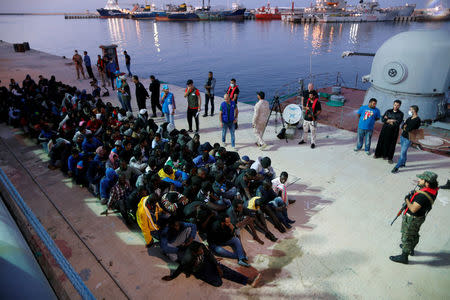 FILE PHOTO: Migrants arrive at a naval base after they were rescued by Libyan Navy, in Tripoli, Libya November 4, 2017. REUTERS/Ahmed Jadallah