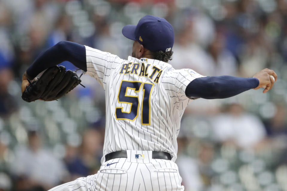 Milwaukee Brewers' Freddy Peralta pitches during the first inning of a baseball game against the Cincinnati Reds, Saturday, July 10, 2021, in Milwaukee. (AP Photo/Aaron Gash)