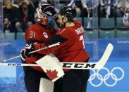 Ice Hockey - Pyeongchang 2018 Winter Olympics - Man’s Quarterfinal Match - Canada v Finland - Gangneung Hockey Centre, Gangneung, South Korea - February 21, 2018 - Goalie Kevin Poulin and Gilbert Brule of Canada celebrate victory. REUTERS/David W Cerny