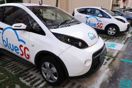BlueSG electric car-sharing vehicles are parked at a charging station in a public housing estate in Singapore December 12, 2017. REUTERS/Edgar Su